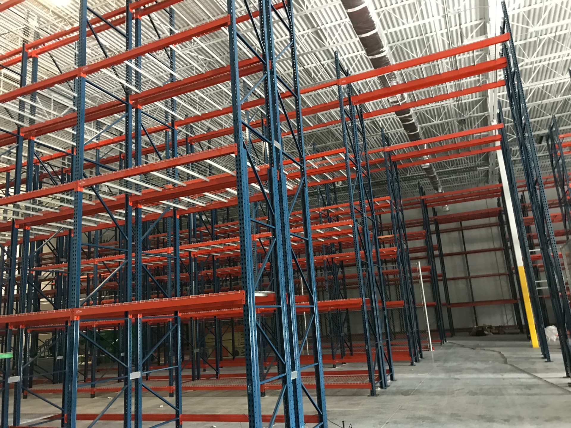 Tall selective pallet rack rows with wire decking