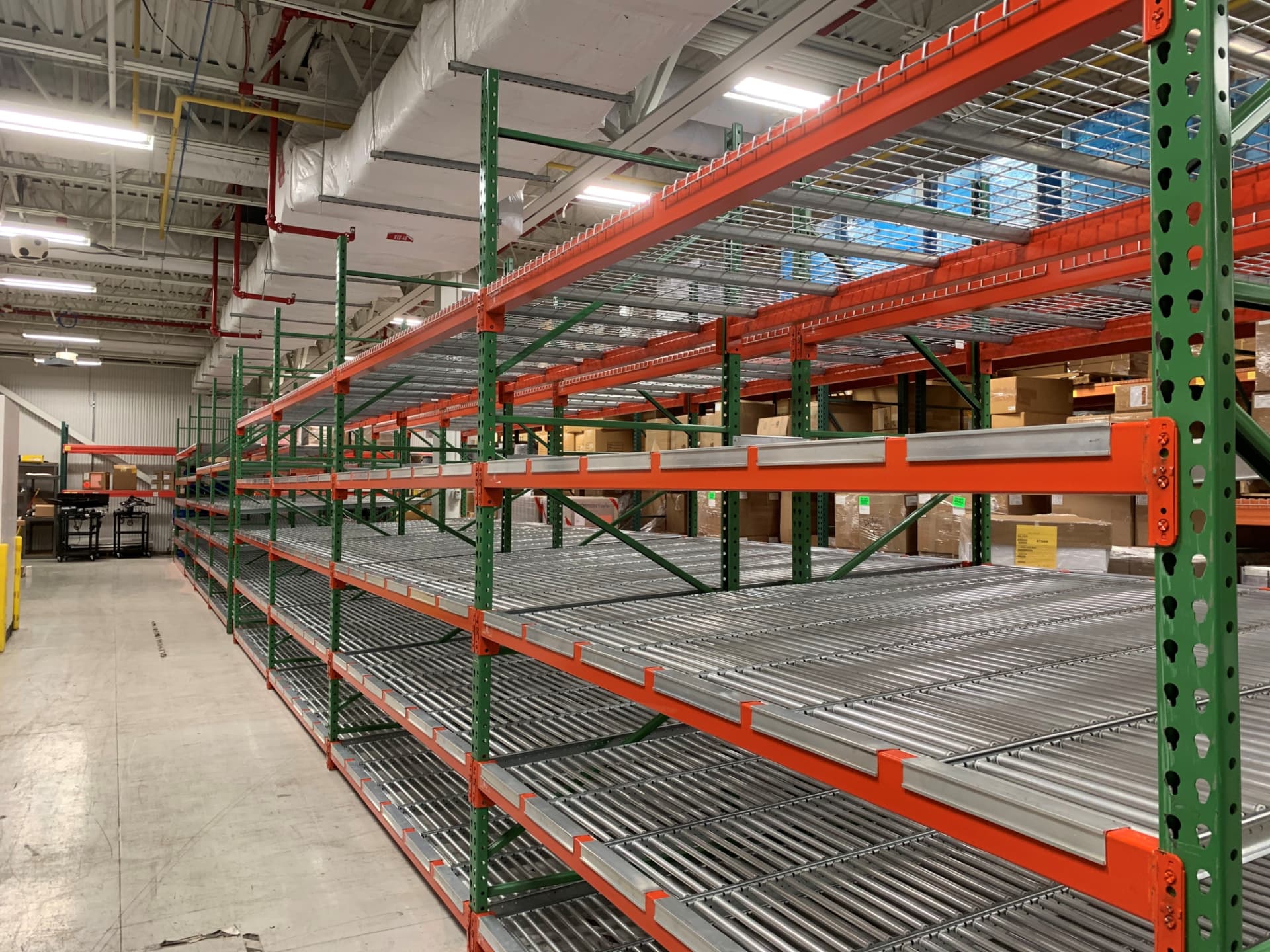 Carton flow rack lanes installed beneath pallet rack bays